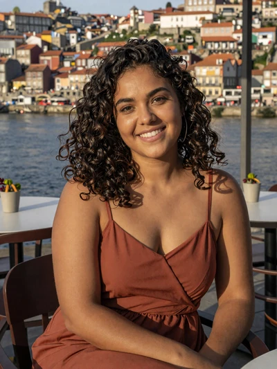 Elena, 28, a radiant Portuguese woman at an outdoor Porto cafe with river view