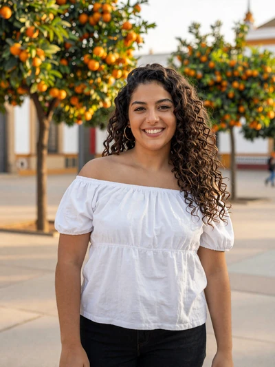 Isabel, 26, a Spanish woman smiling in a sunny Seville plaza