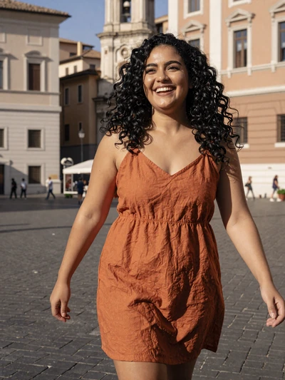 Rosaria, 28, a joyful Italian woman with curly black hair in a sunlit Roman piazza