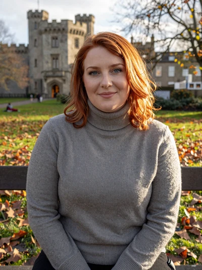 Caoimhe, 30, a red-haired Irish woman sitting in a Limerick park near King Johns Castle