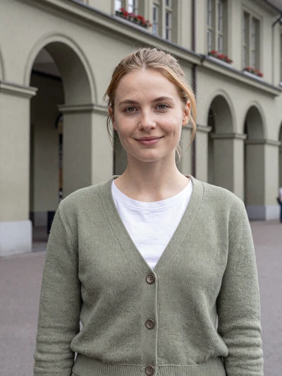 Noemi, 28, a Swiss woman with auburn hair in front of Bern old town arcades